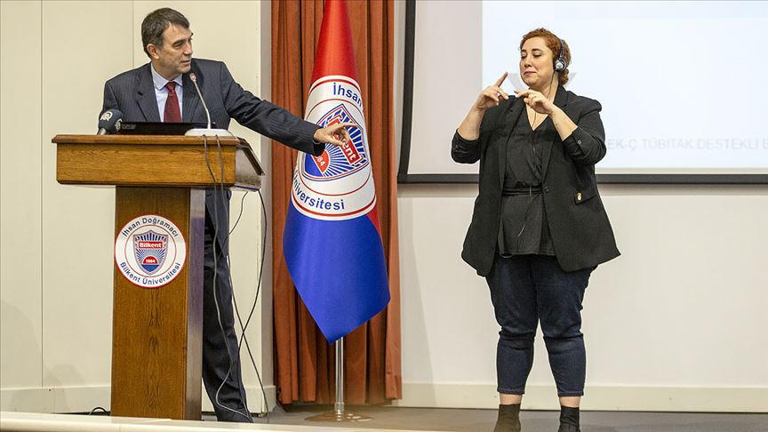 Akademisyenler `Medyada Engelsiz Erişimde Kaliteli Çeviri` İçin Toplandı Bilkent Üniversitesi Rektörü Prof. Dr. Abdullah Atalar kürsüde konuşurken sağda siyah ceketli kadın bir işaret dili çevirmeni konuşulanları çeviriyor.